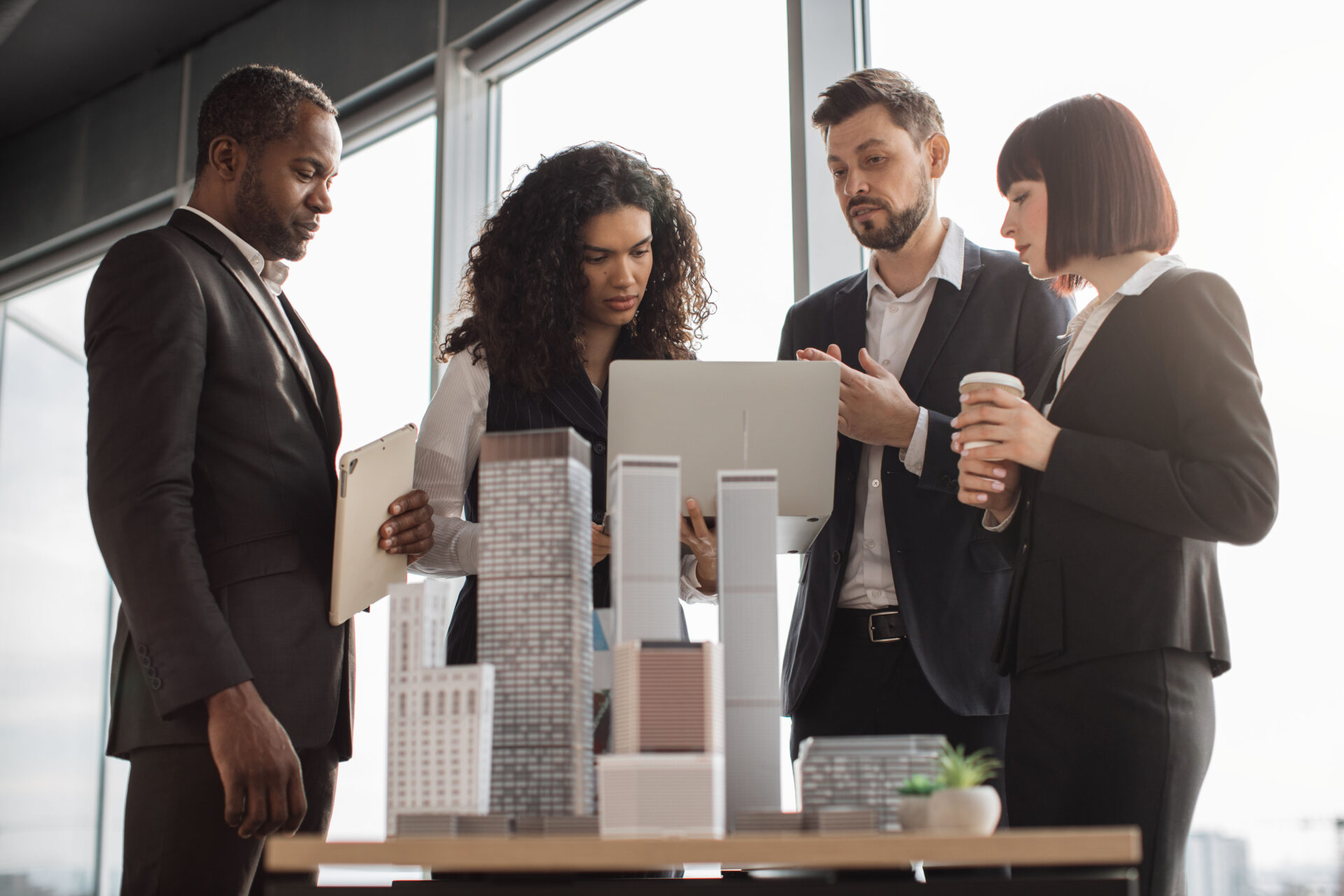 Team discussing with miniature building models in front of them