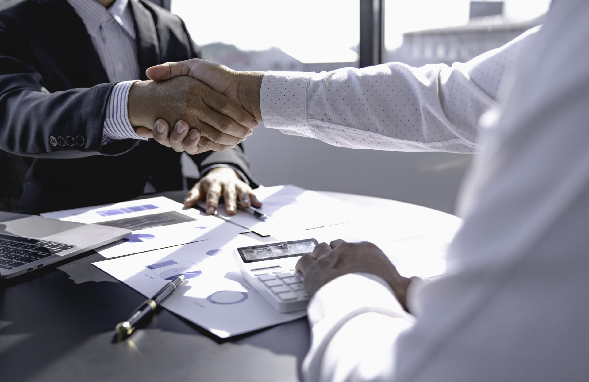 business people shaking hands in office 