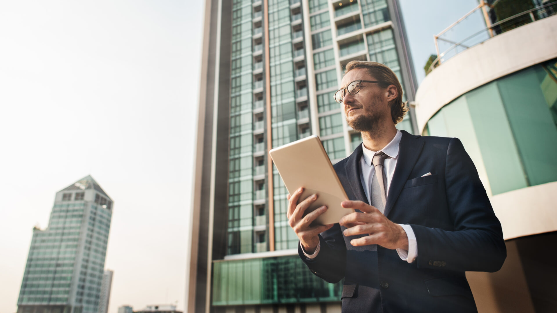 businessman walking holding tablet