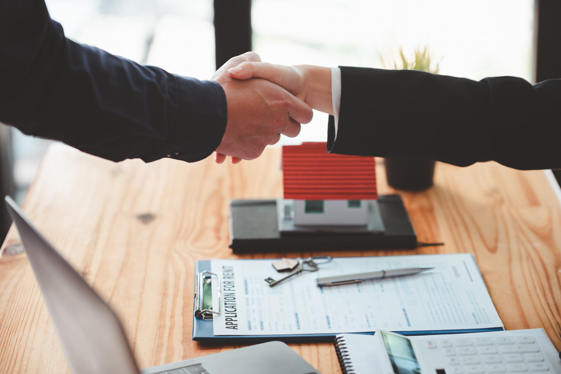 Businessmen shake hands to congratulate each other after discussing the contract.