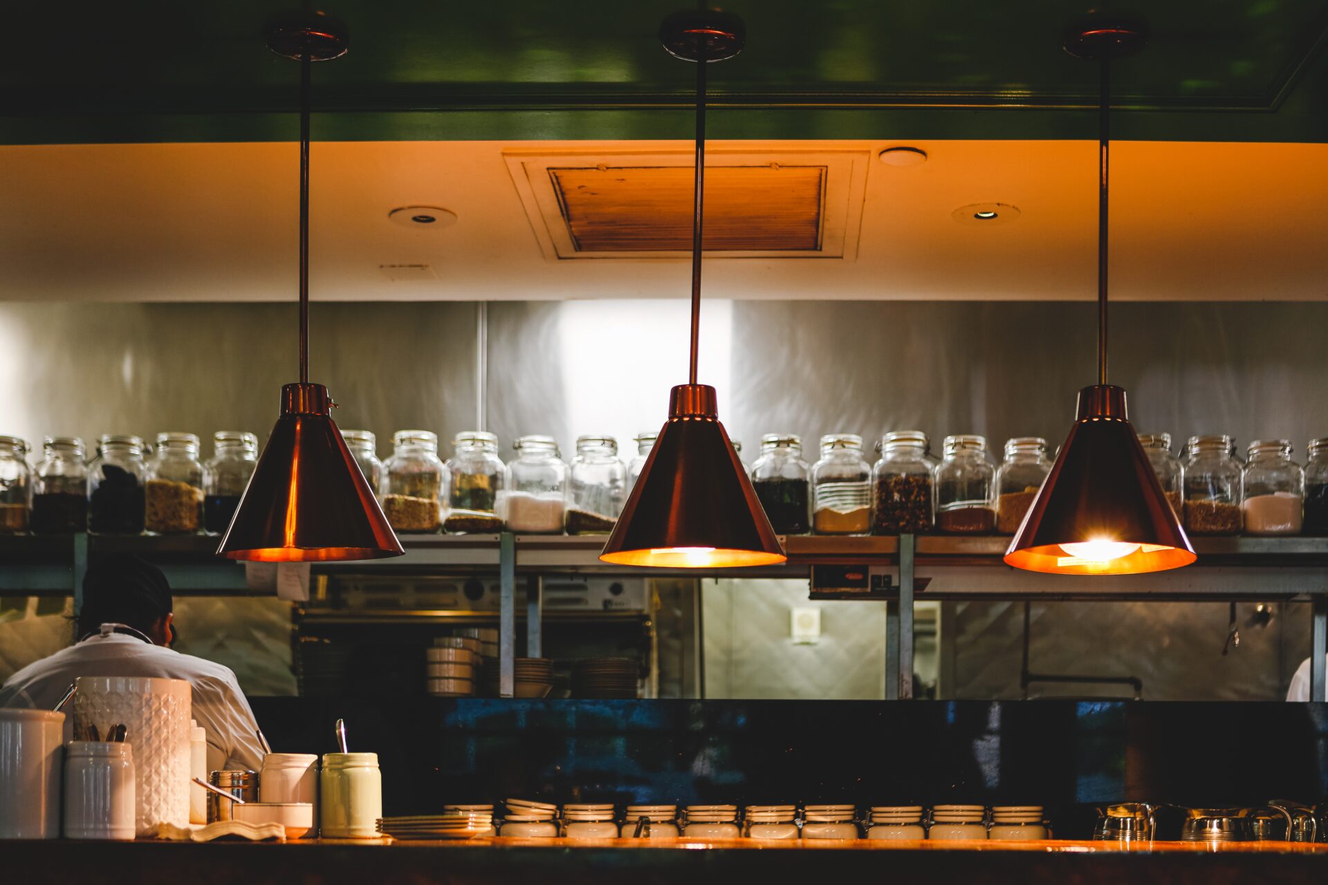 copper and iron lamps in front of the open kitchen 2026 01 07 01 39 09 utc