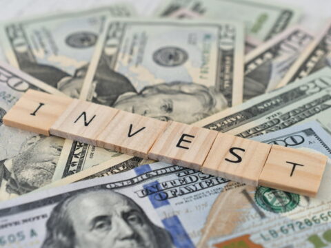currency with word invest on top in wooden letter 2026 01 09 00 35 49 utc (1)
