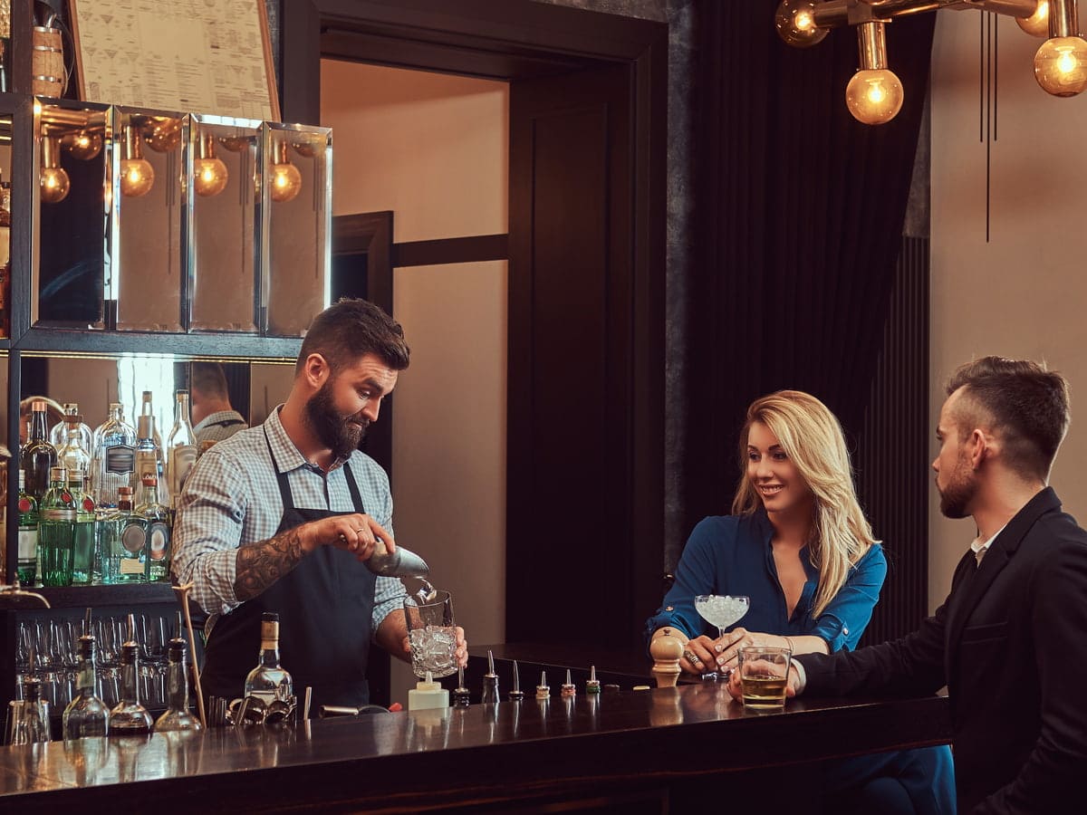 elegant bar scene with bartender serving customers 2026 03 17 03 24 45 utc (1)