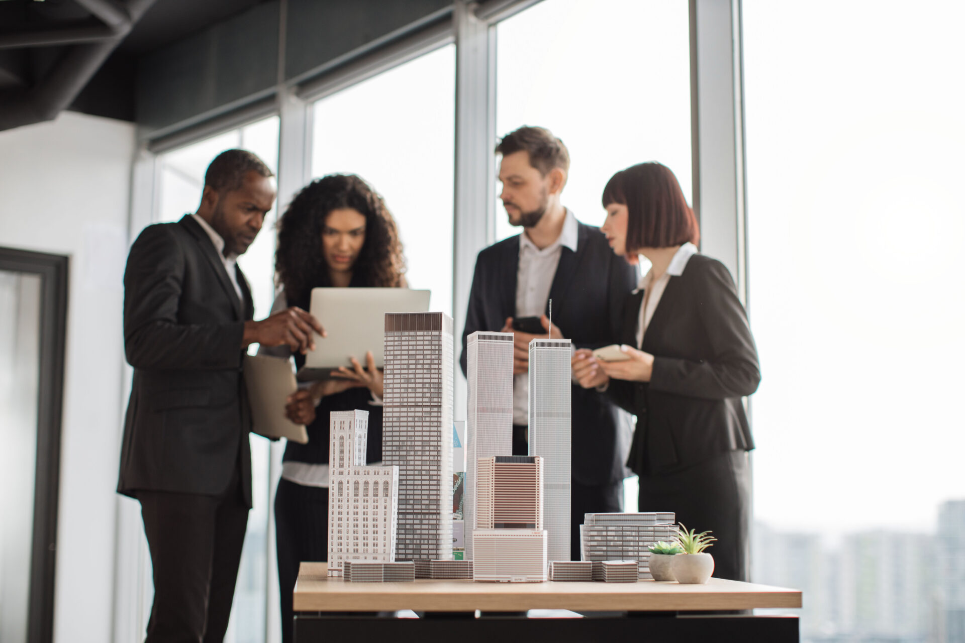 Elegant diverse business team working in modern office for commercial real estate investment.