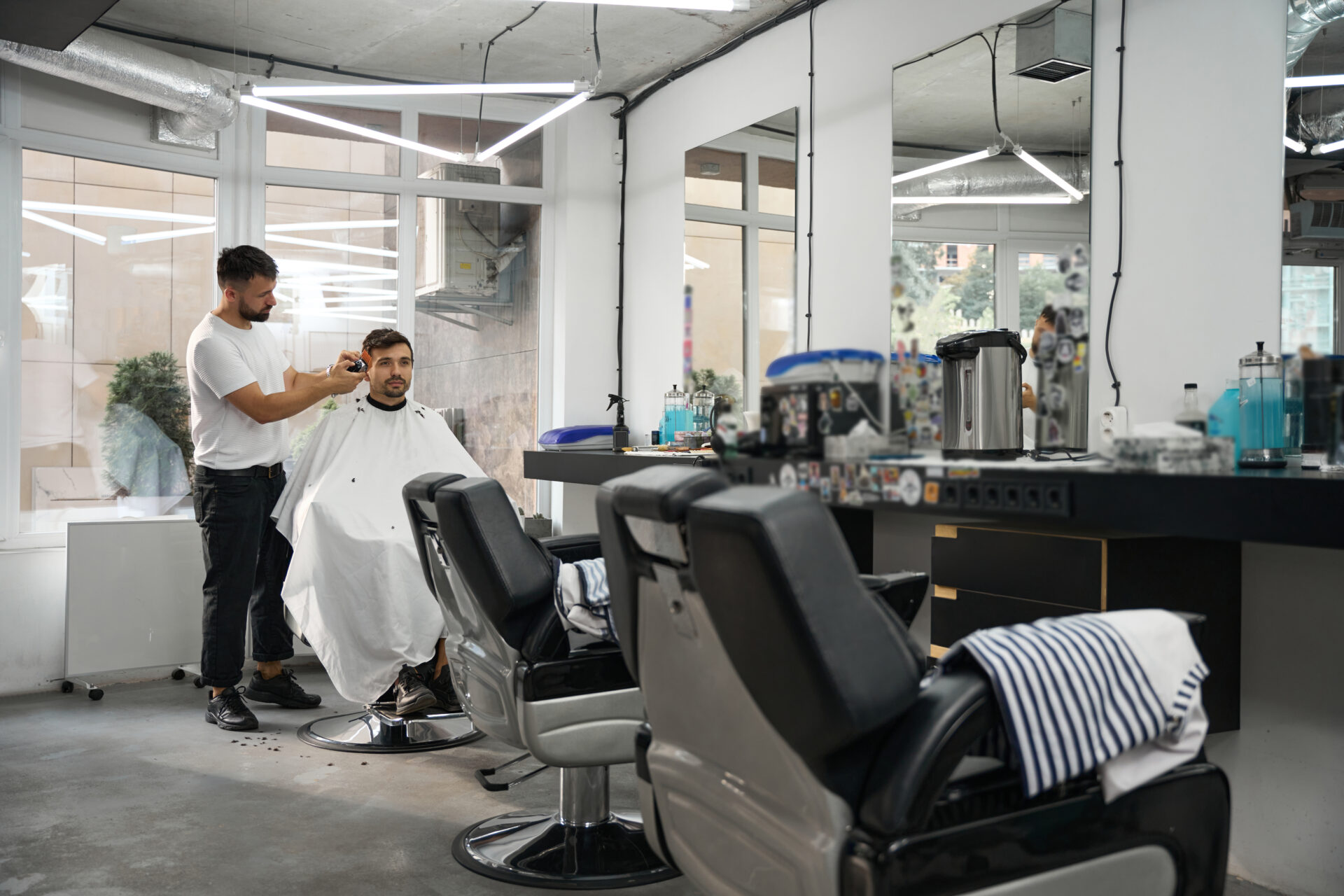 hairstyle specialist doing his best while grooming gentleman hair