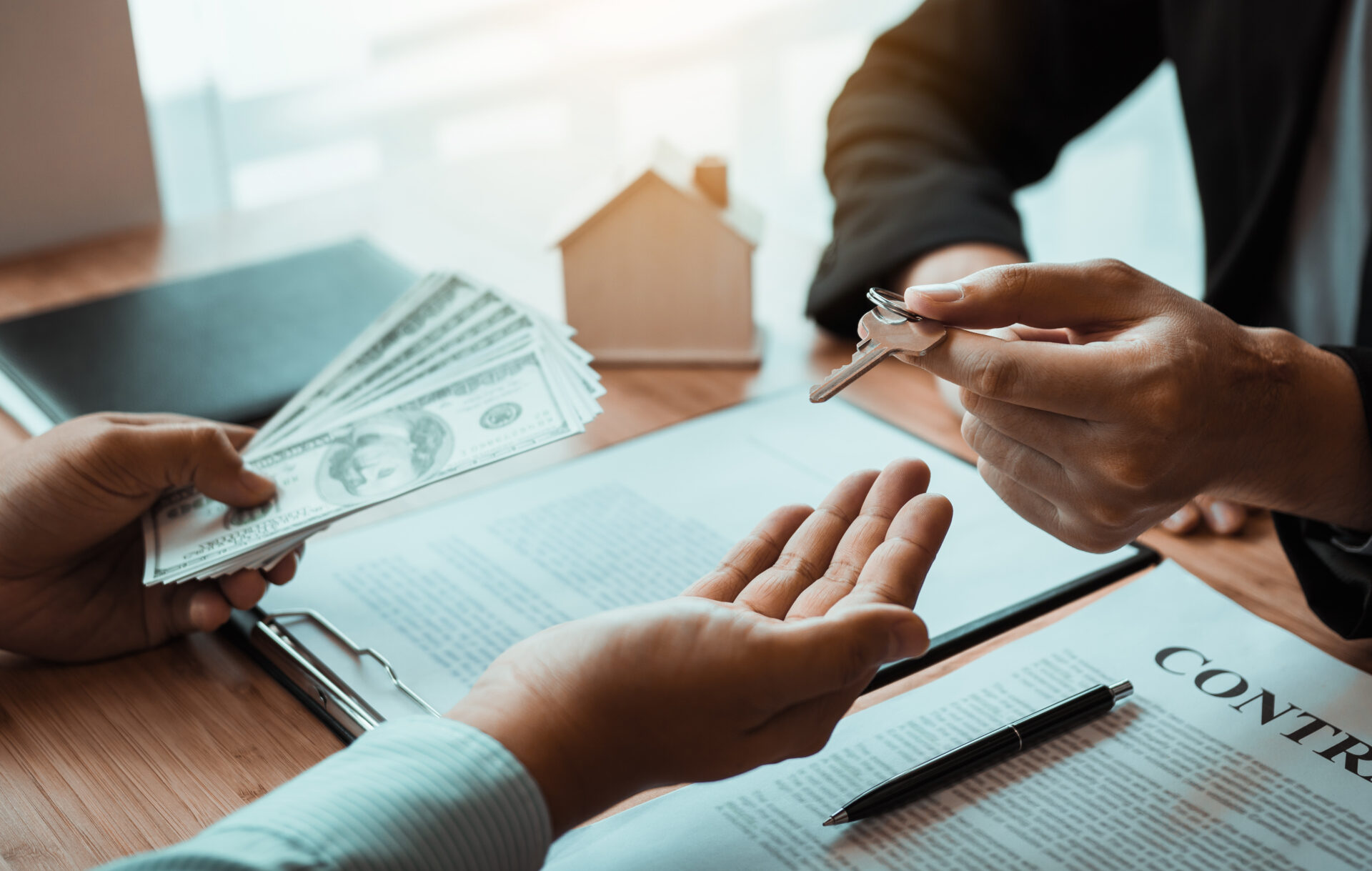 home agents are handing out keys to home buyers who are signing