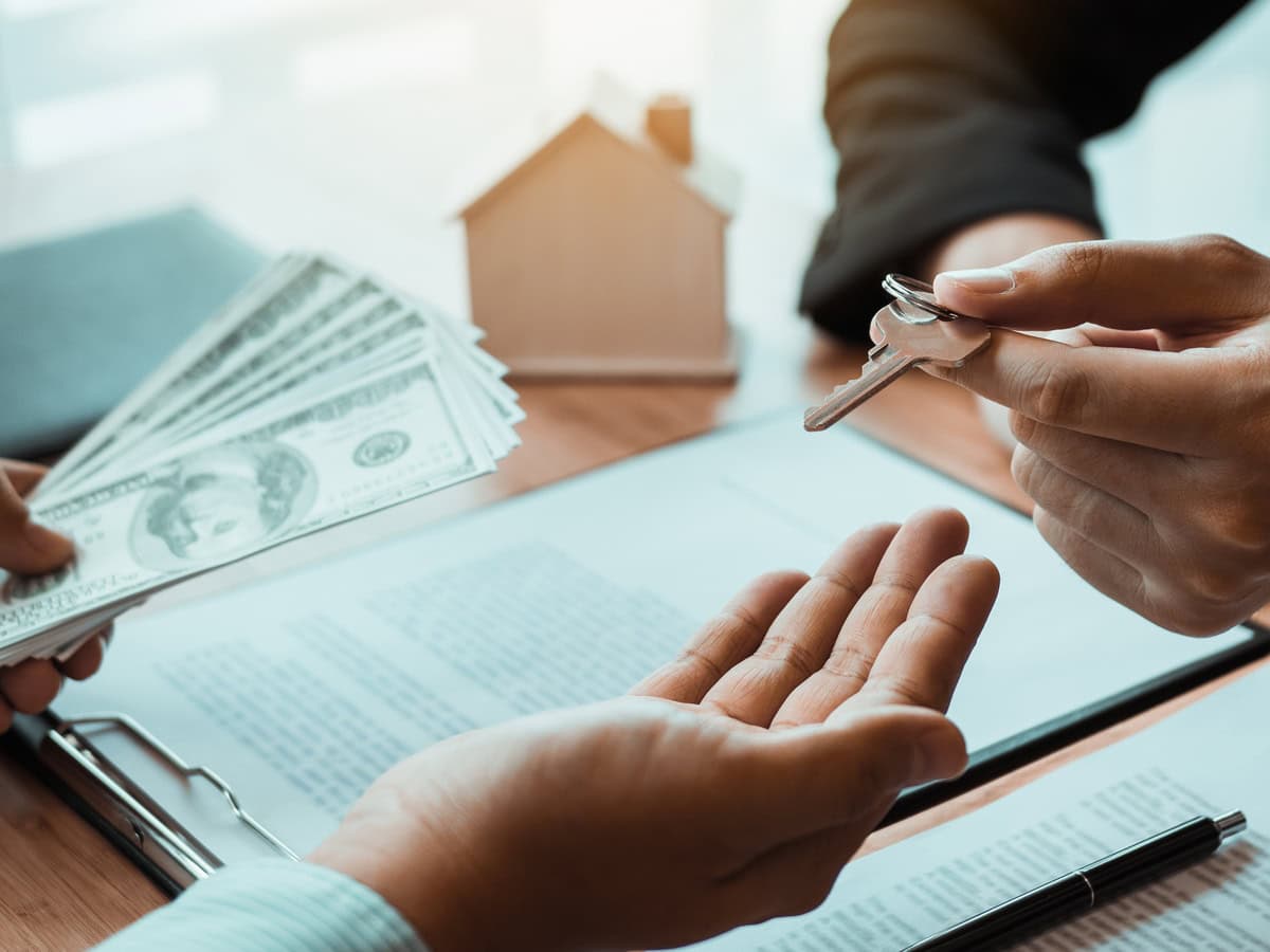 home agents are handing out keys to home buyers who are signing