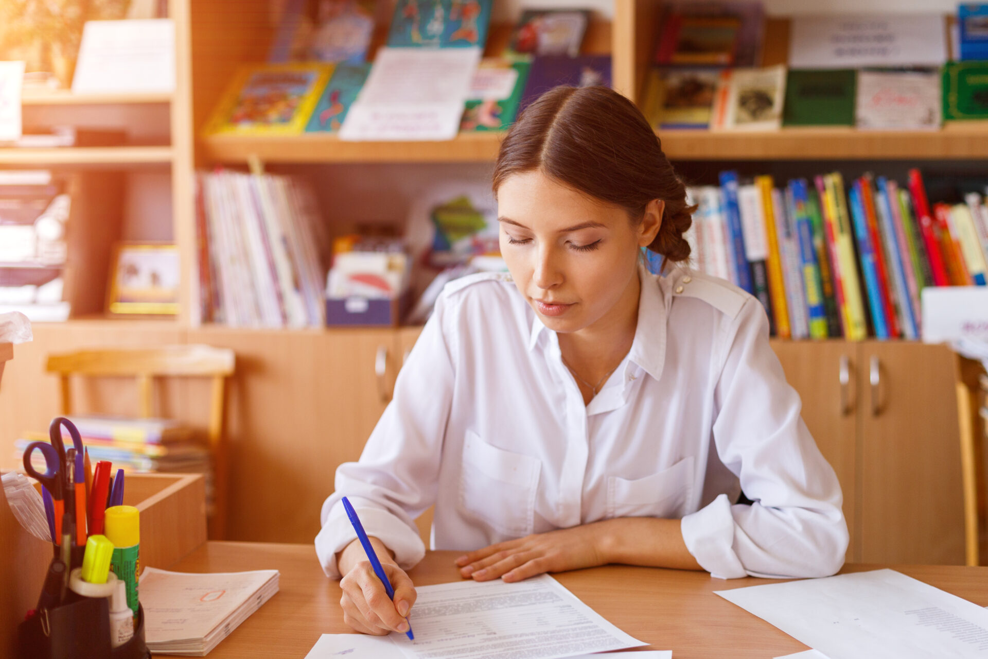 pensive young business woman planning work schedule writing in notebook