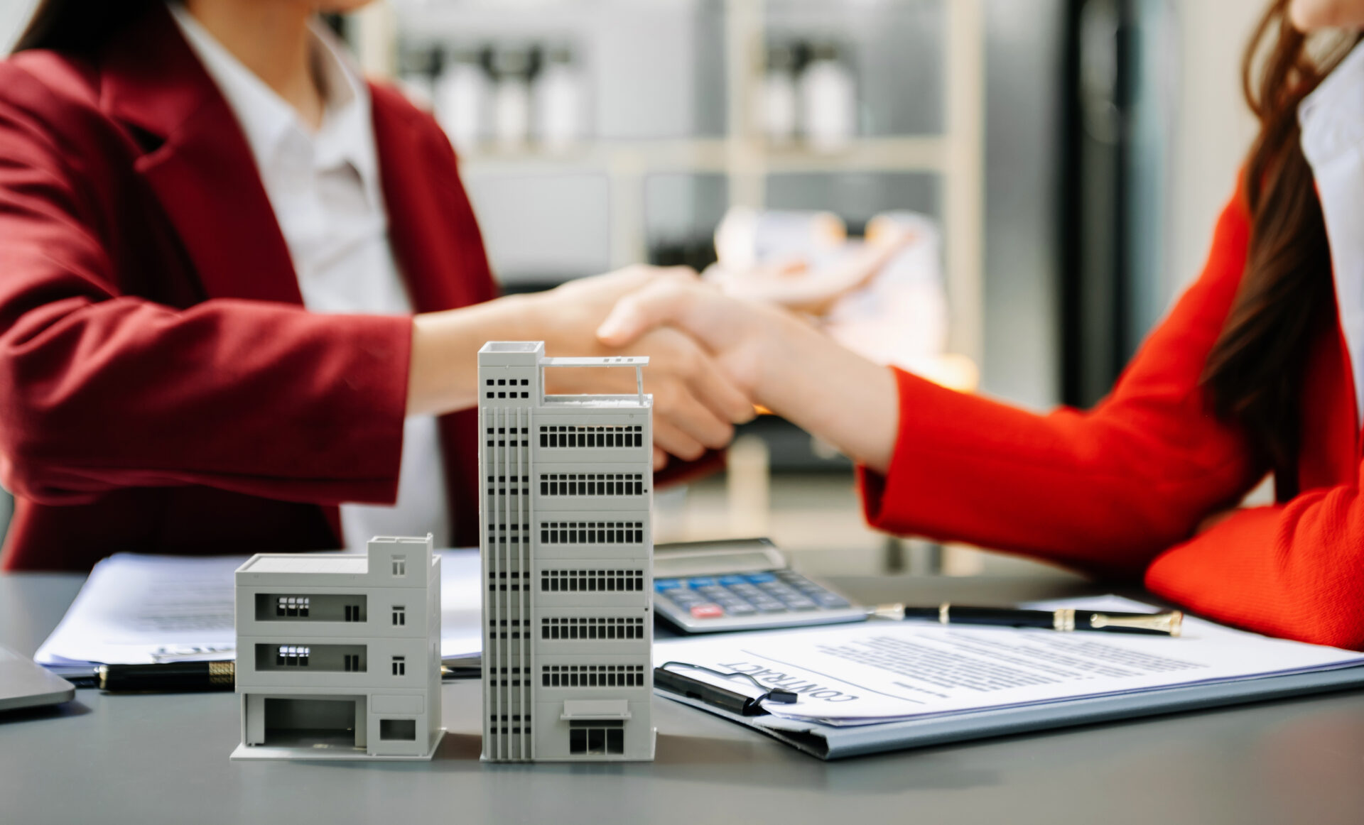 Signing a contract. Client and broker agent, lease agreement, successful deal and  Young business sitting at the desk in modern office