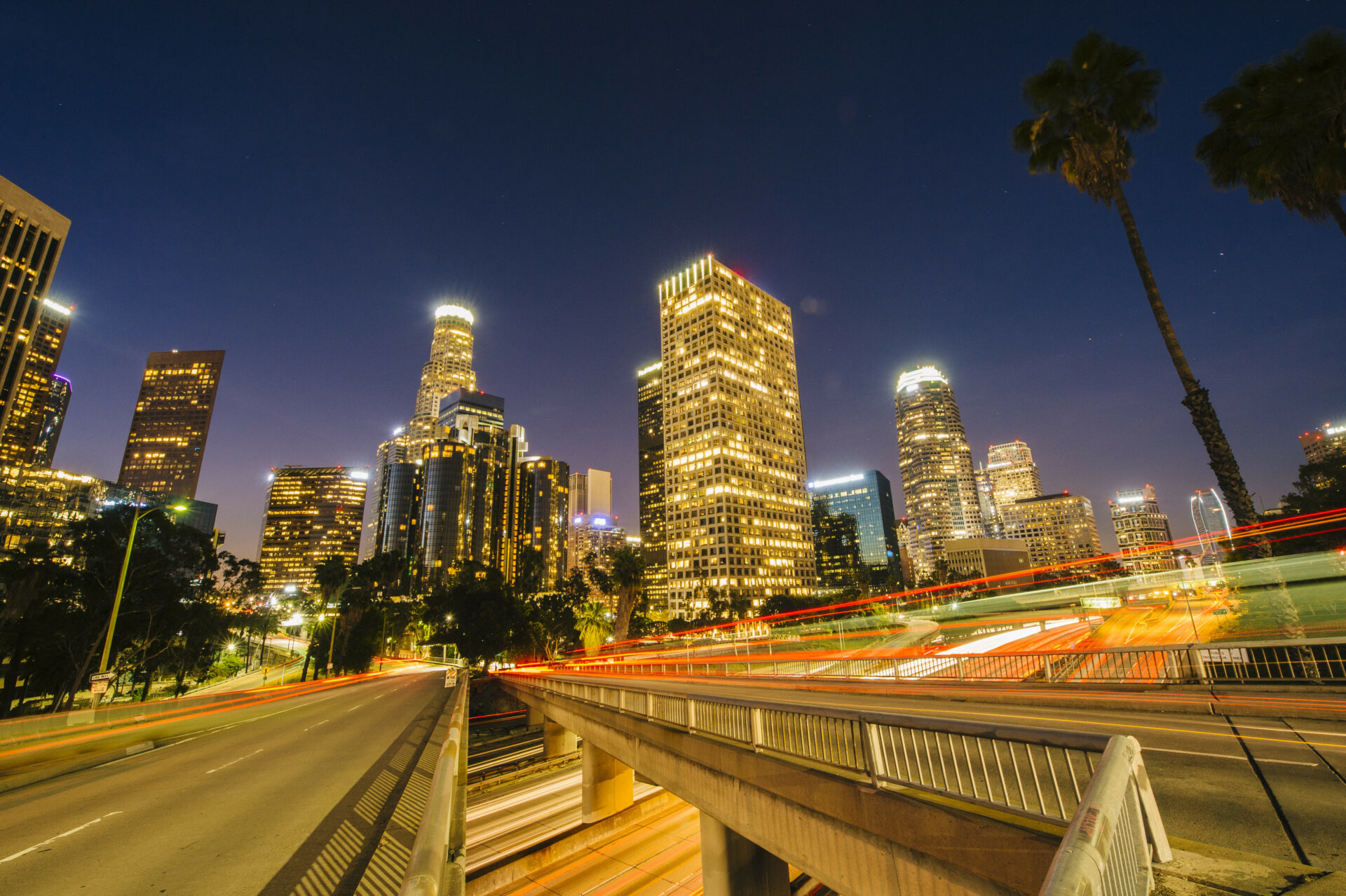 view of city skyscrapers and highway at night, los angeles, california, usa