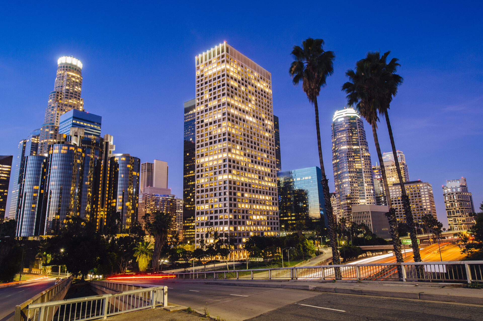 view of highway and city skyline at dusk, los angeles, california, usa